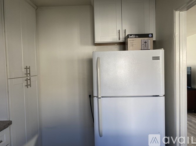 A room with a white door and shelves inside.