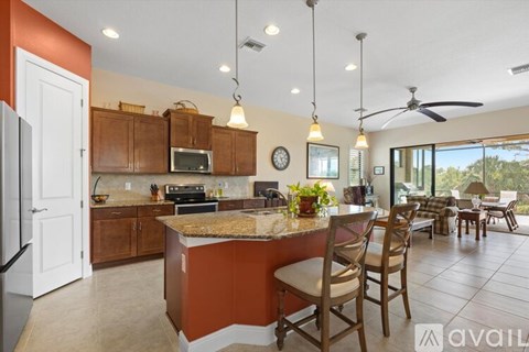 A kitchen with a brown counter and a white fridge.