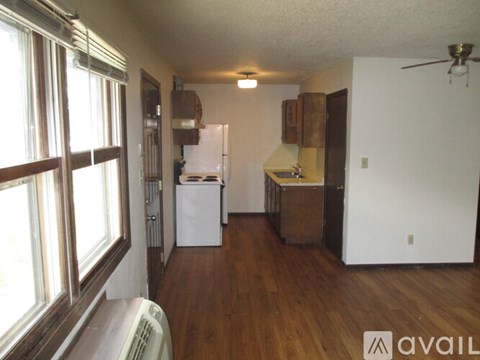 A kitchen with a refrigerator, oven, and sink.