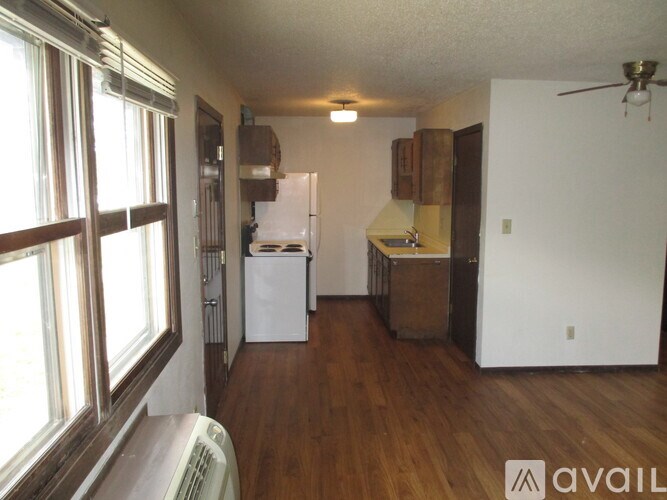 A kitchen with a refrigerator, oven, and sink.