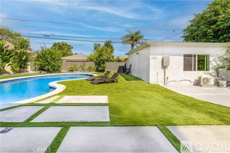 A house with a pool in the backyard.