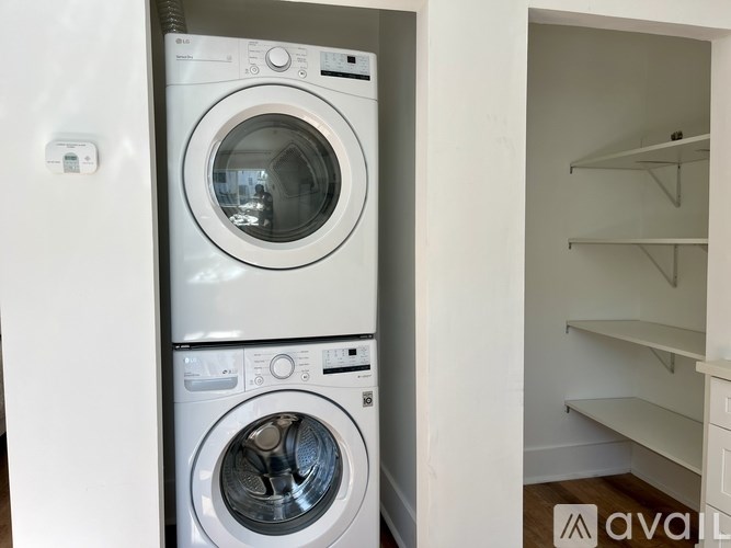 A stacked washer and dryer in a small laundry room.
