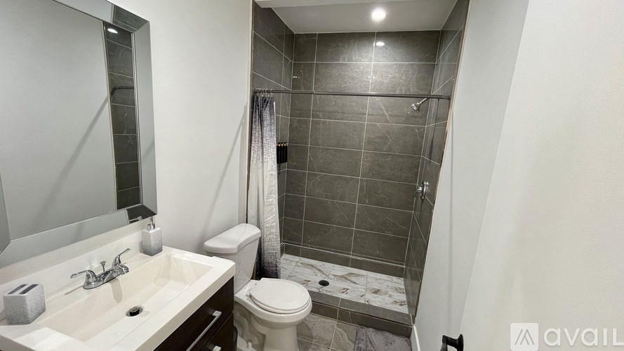 A bathroom with a sink, toilet, and shower.
