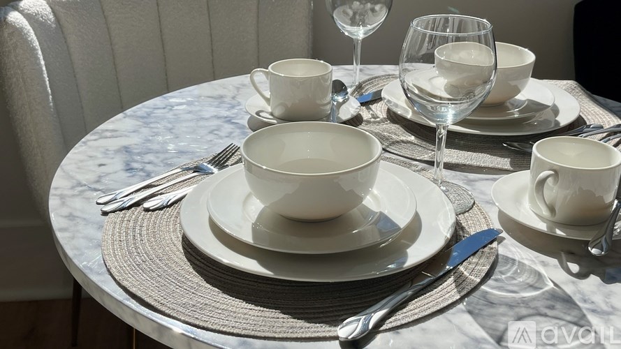 A table set with plates, glasses, and cutlery.