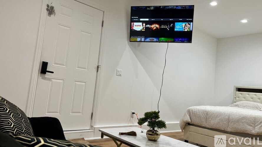 A living room with a flat screen TV mounted on the wall.
