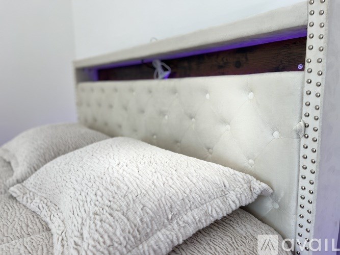 A white pillow with a textured cover sits on a bed.