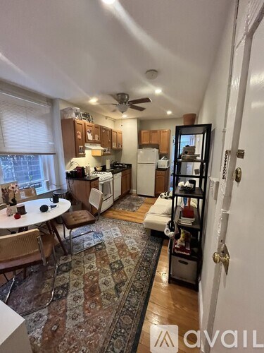 A kitchen with a table and chairs in front of a window.