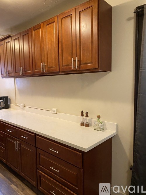 Brown cabinets above a counter with drawers below.