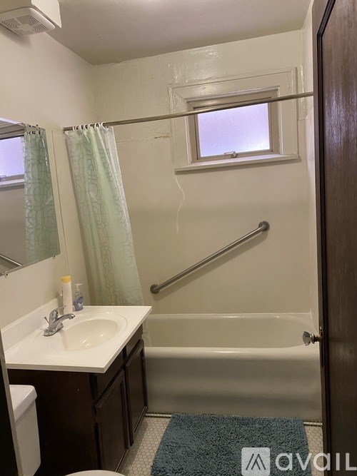 A bathroom with a sink, toilet, and bathtub.
