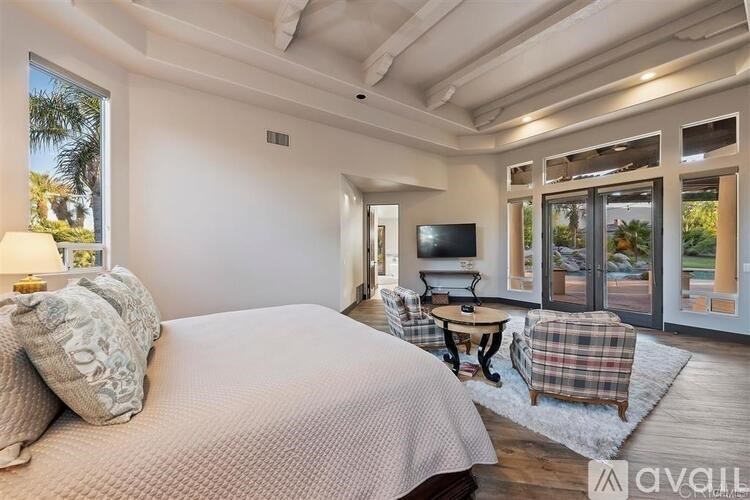 A bedroom with a large bed and a flat screen TV.