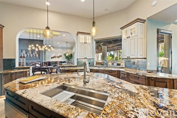 A kitchen with a granite countertop and a sink.