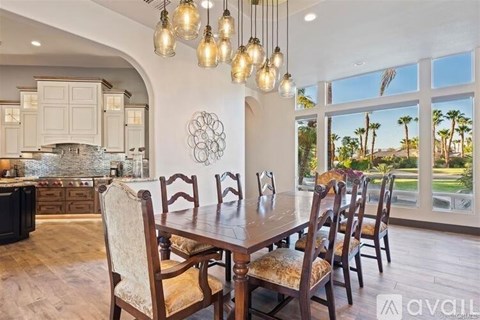 A dining room with a table set for six.