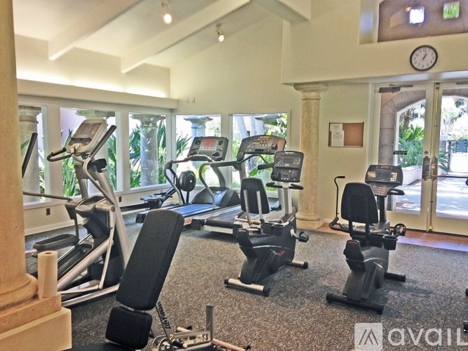 A gym with treadmills, elliptical machines, and other exercise equipment.