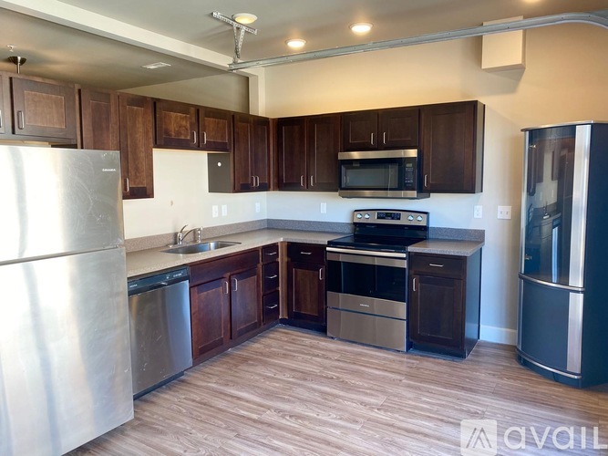 A kitchen with wooden cabinets and stainless steel appliances.
