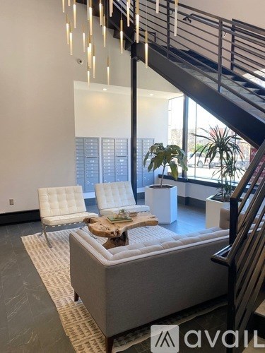 A living room with a couch, chairs, and a coffee table.