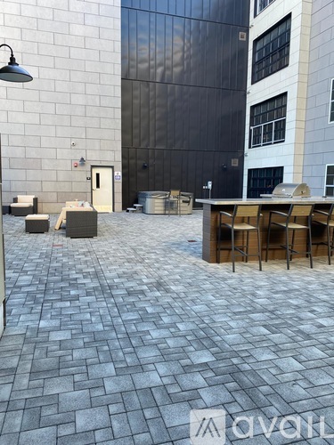 A patio with a table and chairs is in front of a building.
