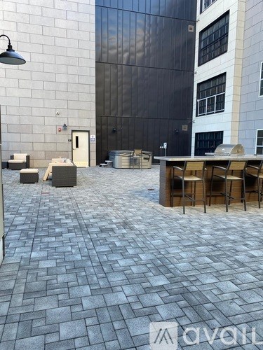 A patio with a table and chairs is in front of a building.
