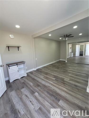 A shower area with a glass door and a drain in the floor.