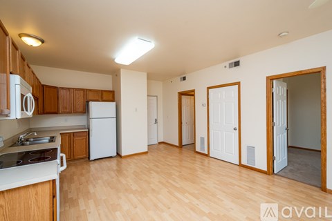 A kitchen with wooden cabinets and a white stove top oven.