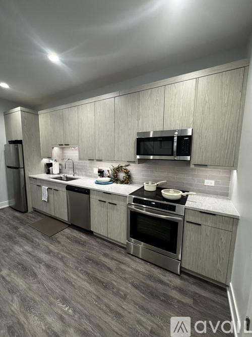 A kitchen with a grey floor and white walls.