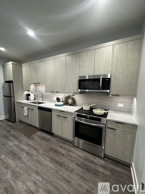 A kitchen with a grey floor and white walls.