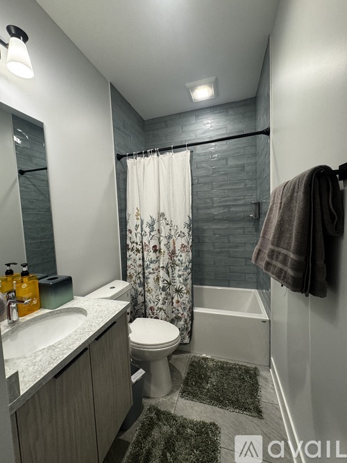 A bathroom with a toilet, sink, and shower.