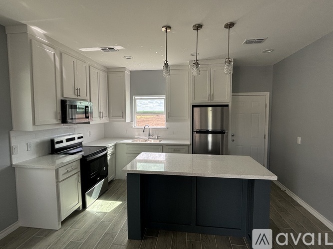 A modern kitchen with a large island in the center.