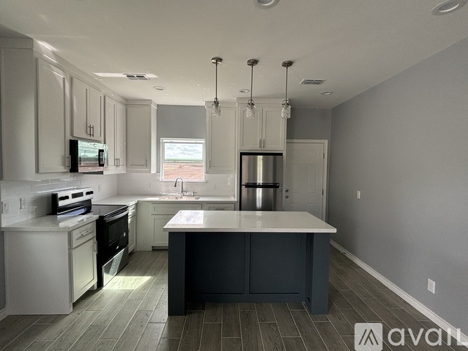 A modern kitchen with a large island in the middle.
