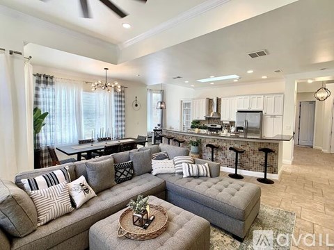 A living room with a grey couch and a coffee table.