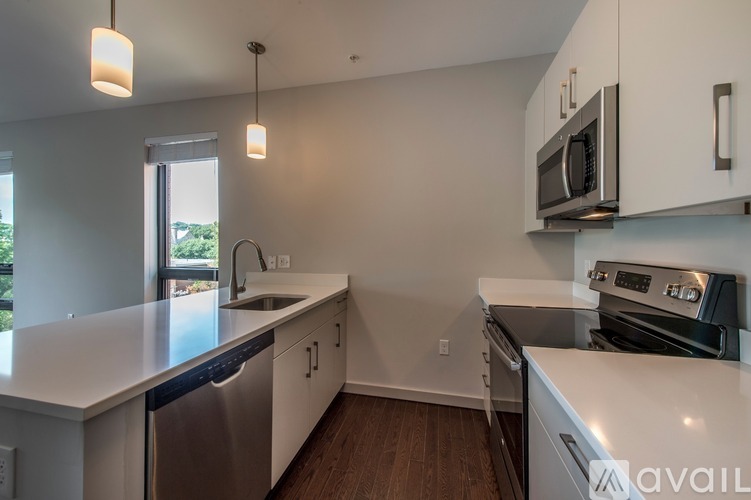 A kitchen with white cabinets and stainless steel appliances.