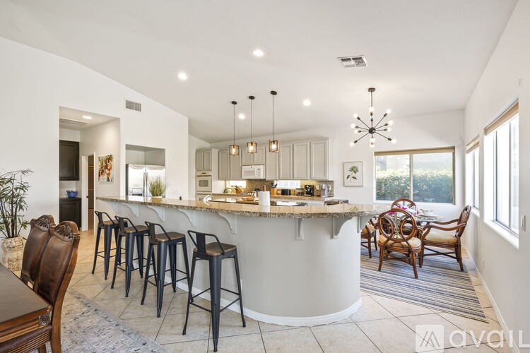 A modern kitchen with a bar area and a dining table set up.