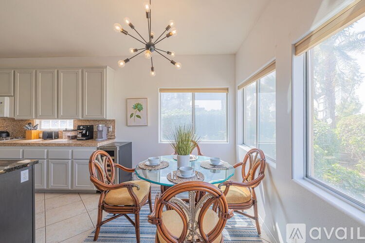 A dining room with a glass table and chairs.