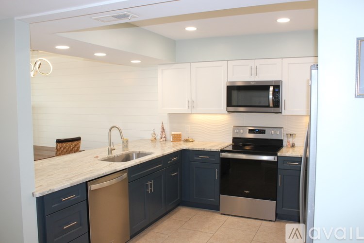 A kitchen with a sink, stove, and oven.
