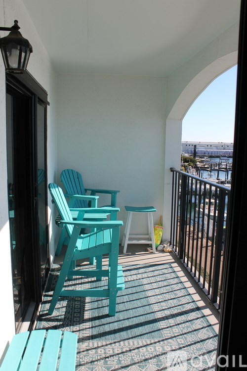 A balcony with a table and chairs.