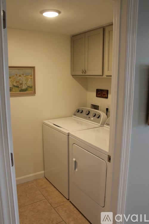A small white washer and dryer in a laundry room.