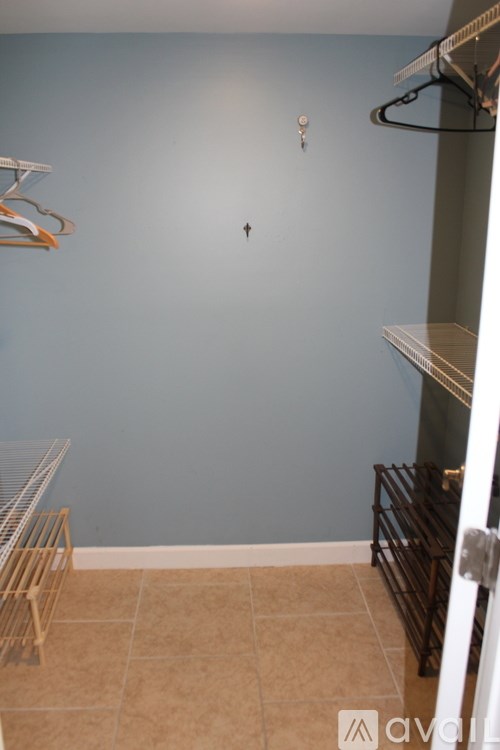 A room with a blue wall and a white door.