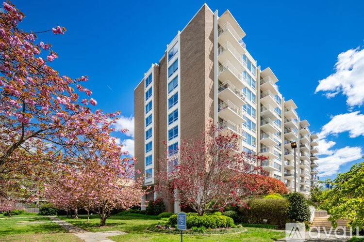 A tall building with a blue sign in front of it.
