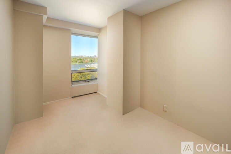 A room with a large window overlooking a body of water.