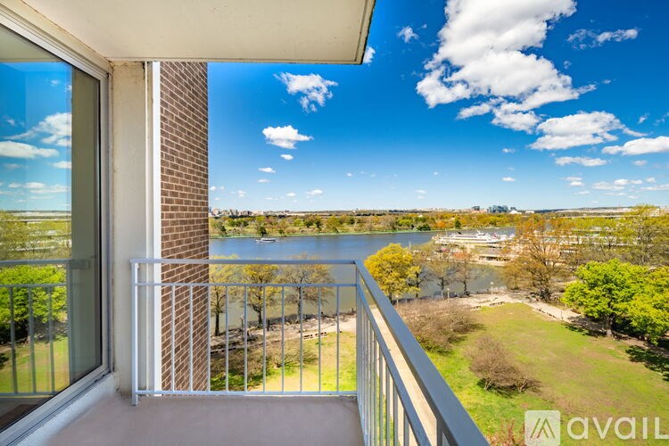 A balcony with a view of a river and a town.