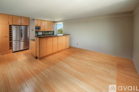 A kitchen with wooden cabinets and a refrigerator.