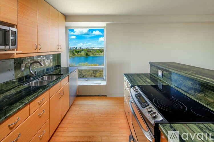 A kitchen with wooden cabinets and a black stove top oven.