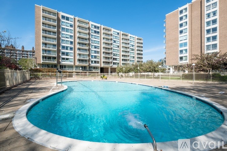 A swimming pool in front of apartment buildings.