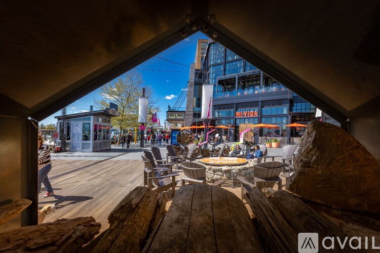 A view from inside a wooden structure looking out onto a bustling city square.