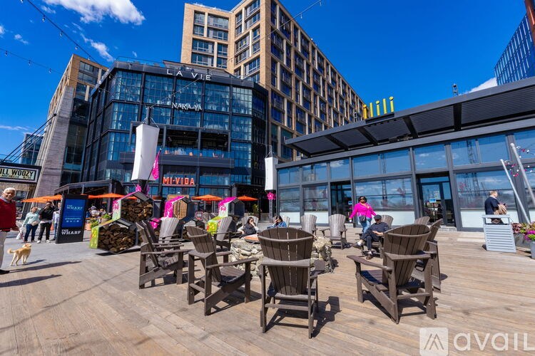 A sunny day at an outdoor seating area with wooden chairs and tables.