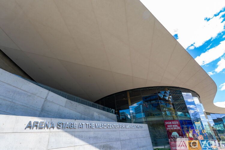 A modern building with a curved wall and a sign that reads "ARENA STAGE AT THE MEAD CENTER FOR THE ARTS".