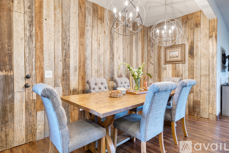 A dining room with a wooden table and blue chairs.
