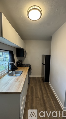 A kitchen area with a sink and a window.