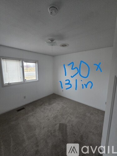 A room with a window and a wall that says 130 x 131m.