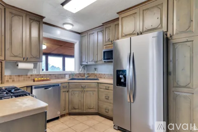 A kitchen with a refrigerator, stove, and microwave.