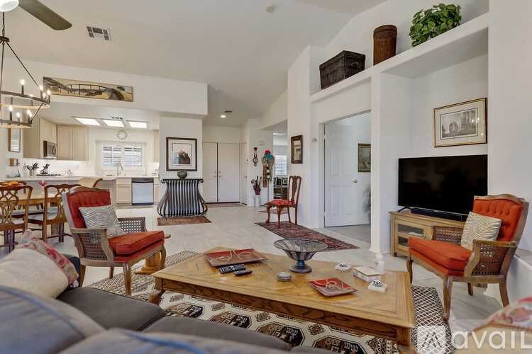 A living room with a couch, chairs, and a coffee table.